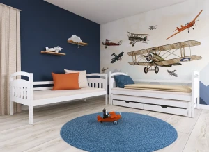 Hvide børnesenge i fly-tema værelse. Den ene med udtræksseng og opbevaring, den anden en enkeltseng.