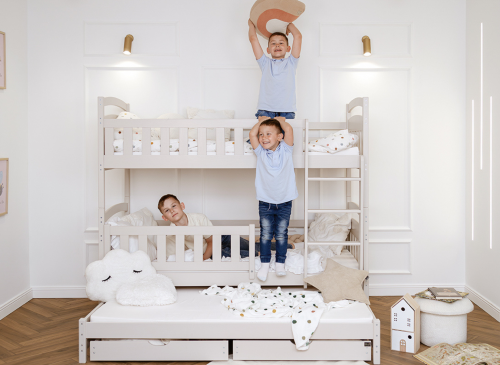 Tre glade drenge leger ved køjeseng med udtræksseng og opbevaring. Legefuldt børneværelse med plads.